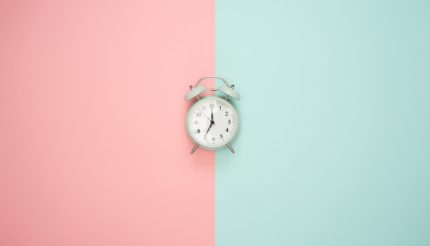 clock on pink and green background