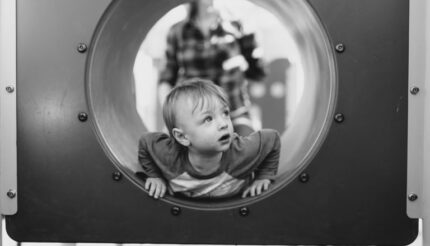 child looking out of tunnel